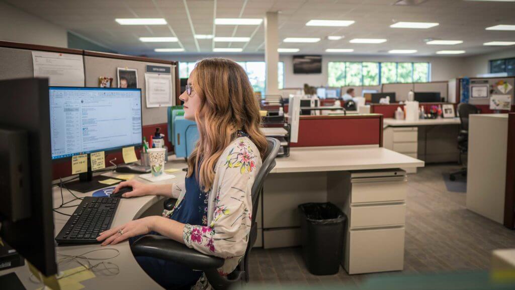 A woman sits at her desk working in Temple, Texas