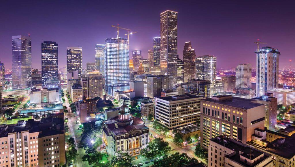 Aerial view of Houston, Texas with tall skyscrapers lit up at night