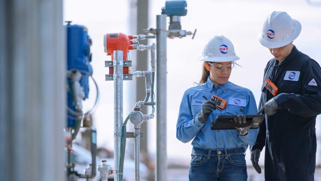 A man and woman at the Occidental plant analyze charts together in Texas