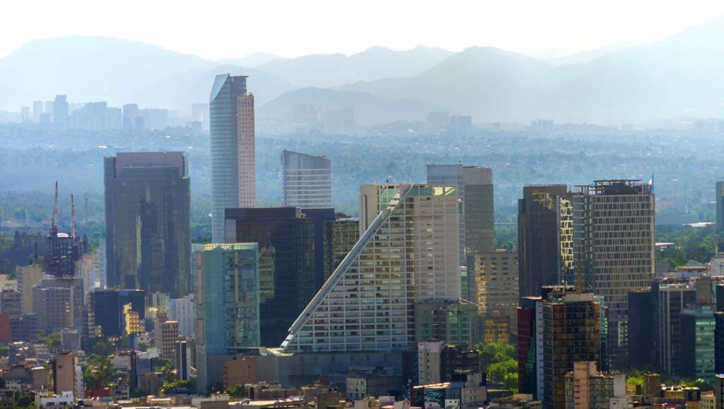 The Mexico City skyline in front of a misty range of mountains