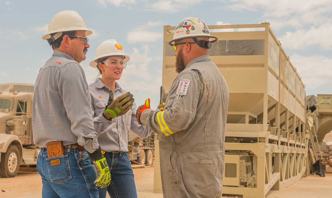 Two men and a woman working at Shell in Texas.