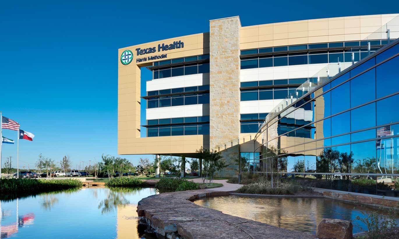 The Texas Health Harris Methodist Hospital in Fort Worth with three flags in front of the building