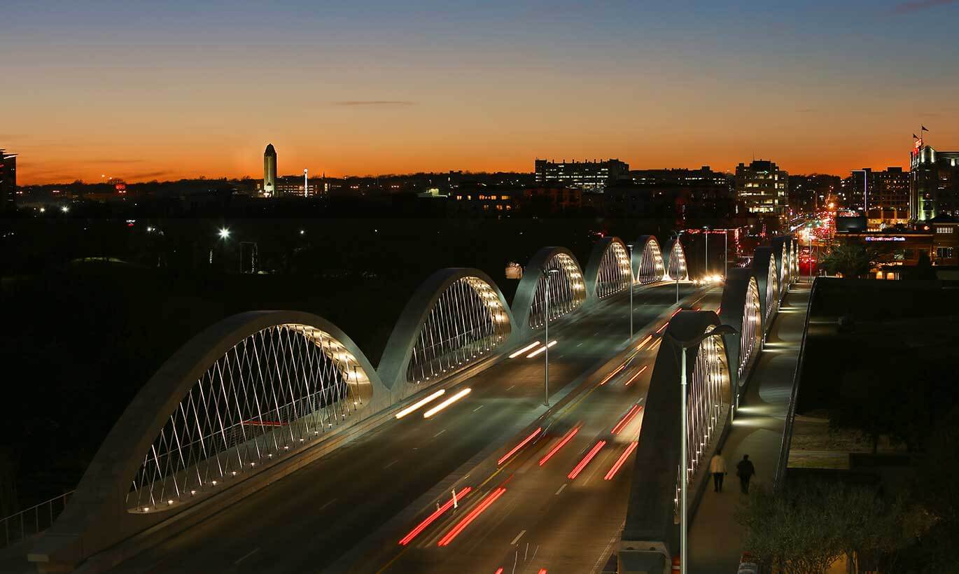 Cars drive on the 7th Street bridge at night in Fort Worth, Texas.