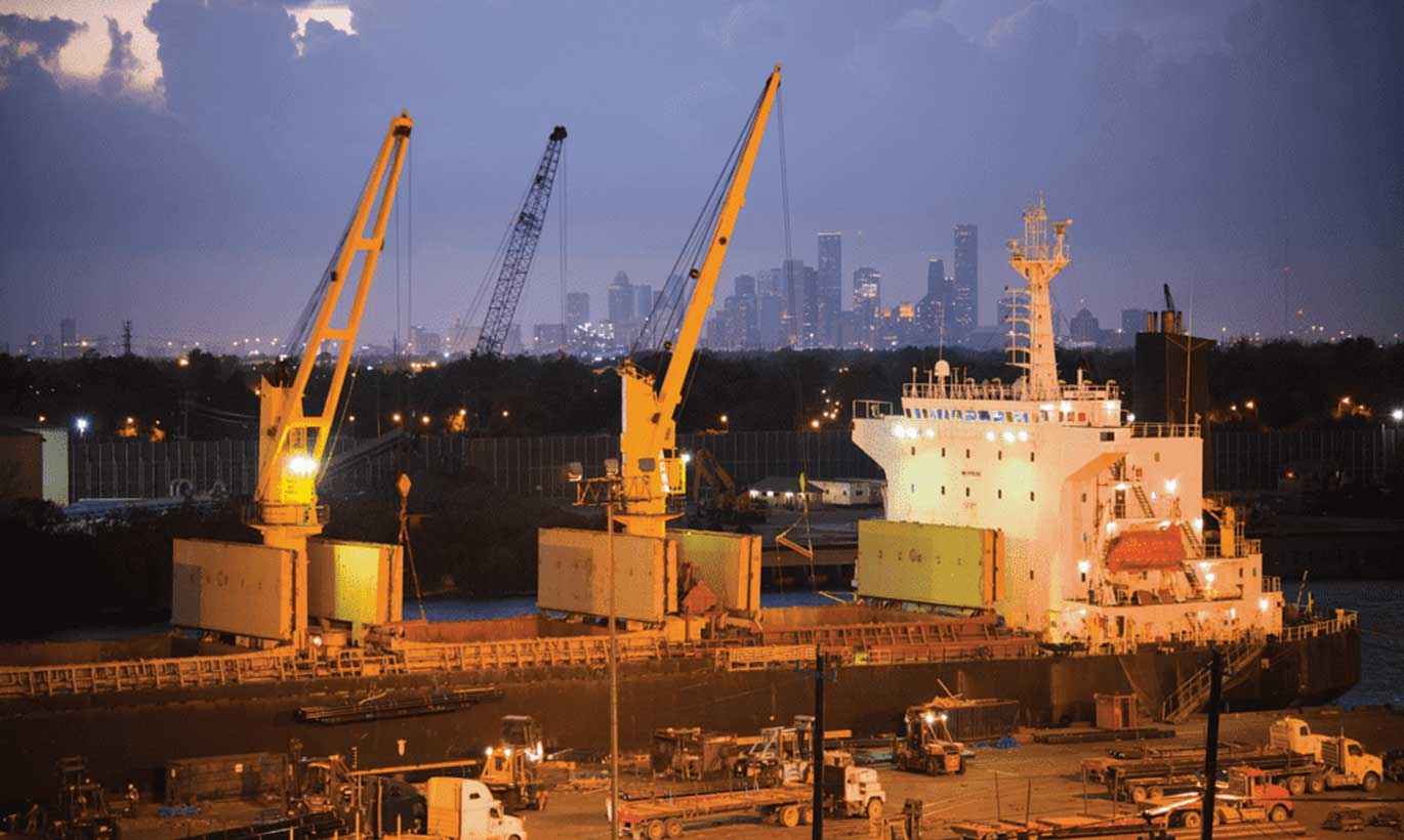 Ships and equipment line a port at sunrise in Texas.