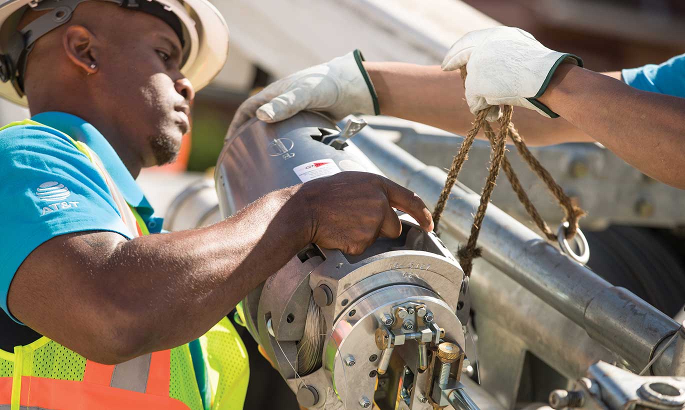 An AT&T worker installs equpment in Texas.